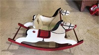 Child's rocking horse with a chair between the