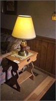 End table with lamp and two pictures on wall
