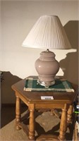 End table, lamp, picture on wall