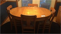 Kitchen table with 4 chairs and items on top
