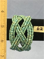 A light blue beaded bracelet (looks like turquoise