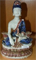 Glazed pottery seated Buddha in blue, white and