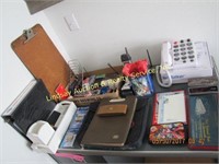 Group of items ontop of desk: notepads,