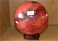 Large coloured glass sphere, spins on wooden stand