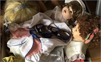 Assorted dolls, doll clothes, book
