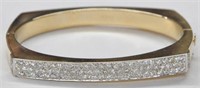 14K BANGLE BRACELET WITH MANY DIAMONDS.