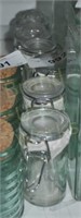 Lot of 4 Cost plus glass canisters with metal