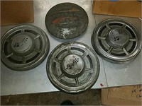 Collection of four Chevrolet hubcaps  including