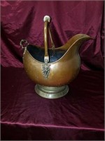 Large copper pitcher with lion faces