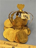 A mini brass colored crown with dangling Philippin