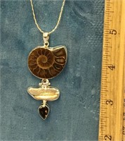 Pendant of sterling silver with ammonite fossil, b