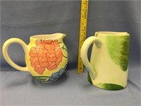 A pair of hand painted pitchers, tallest is approx