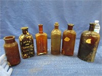 6 antique amber bottles - some embossed