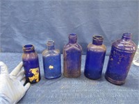 5 antique blue bottles