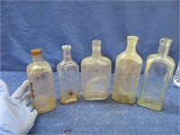 5 antique bottles - embossed (1 cracked)