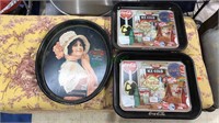 Three Coca-Cola trays, one oval and two