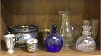 Top shelf lot of metal kitchen items and glass