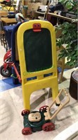 Child's easel chalkboard and a plastic toy