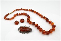 Amber beaded necklace, earrings, and brooch
