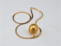 Yellow gold globe pendant on gold chain