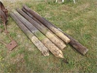 7 CREOSOTED WOODEN FENCE POSTS