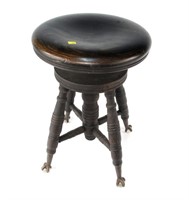 Mahogany piano stool with brass and glass claw and