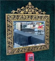 Highly decorated brass framed beveled mirror,