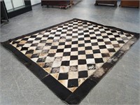 LARGE COWHIDE STITCHED RUG BARE IN PLACES