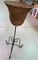 Woven plant holder on metal legs