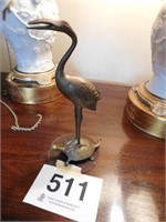 Brass stork on turtle figurine