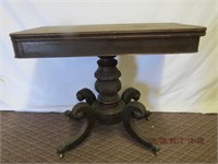 Mahogany fold over games table on carved pedestal