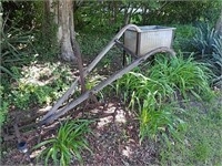 Antique wood and iron plow with a steel wash basin
