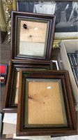 Three matching antique wood frames with a group