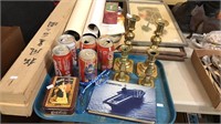Brass candlesticks, Coca-Cola cans, aircraft