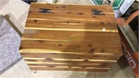 Small child's cedar chest with a few items