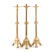 Three ecclesiastical brass candlesticks
