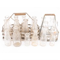 18 glass milk bottles and 2 aluminum carriers