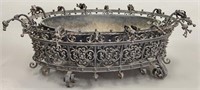 Oval wrought iron planter with elaborate