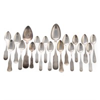 A collection of silver fiddle back spoons