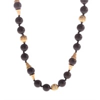 A Lady's Black Onyx and Gold Beaded Necklace