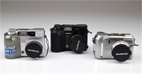 Three Olympus Camedia Cameras and Accessories