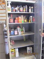 Upright tan metal storage cabinet with solvents,