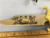 12" hunting knife with a deer design on the blade,