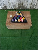 Crate, set of pool balls with triangle.