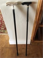2 Black Canes one with a Silver color handle