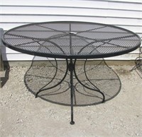 Round wrought iron patio table. Measures 30" high