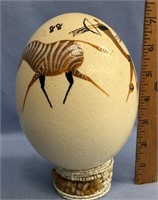 6" painted ostrich egg on a beaded stand     (k 15