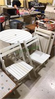 Folding table and four folding chairs with slats