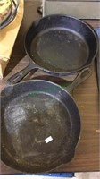 Two cast iron skillets , one marked Favorite