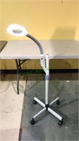 LED light with magnifier on a stand with